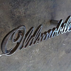 1976 Oldsmobile grille script emblem